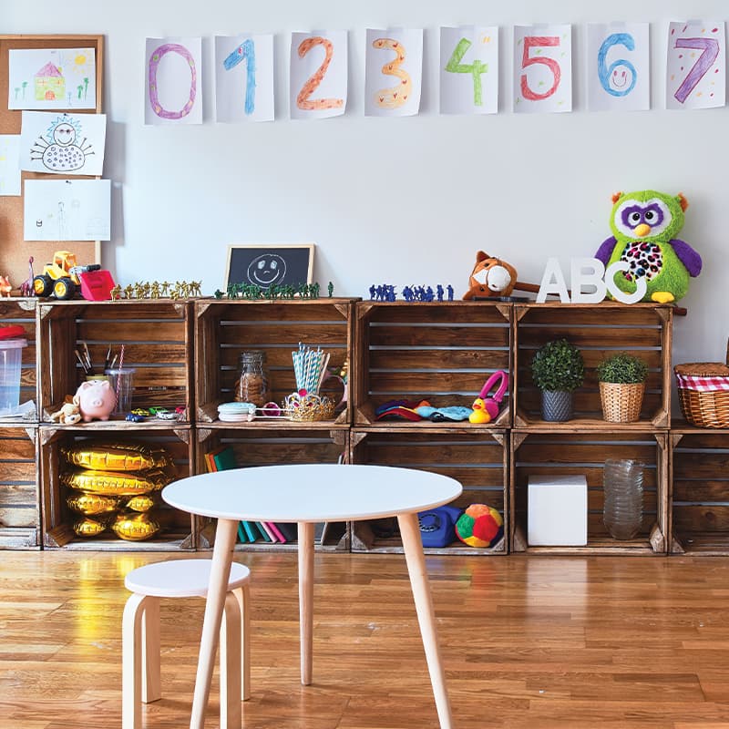 Children's classroom with bookshelf and toys.