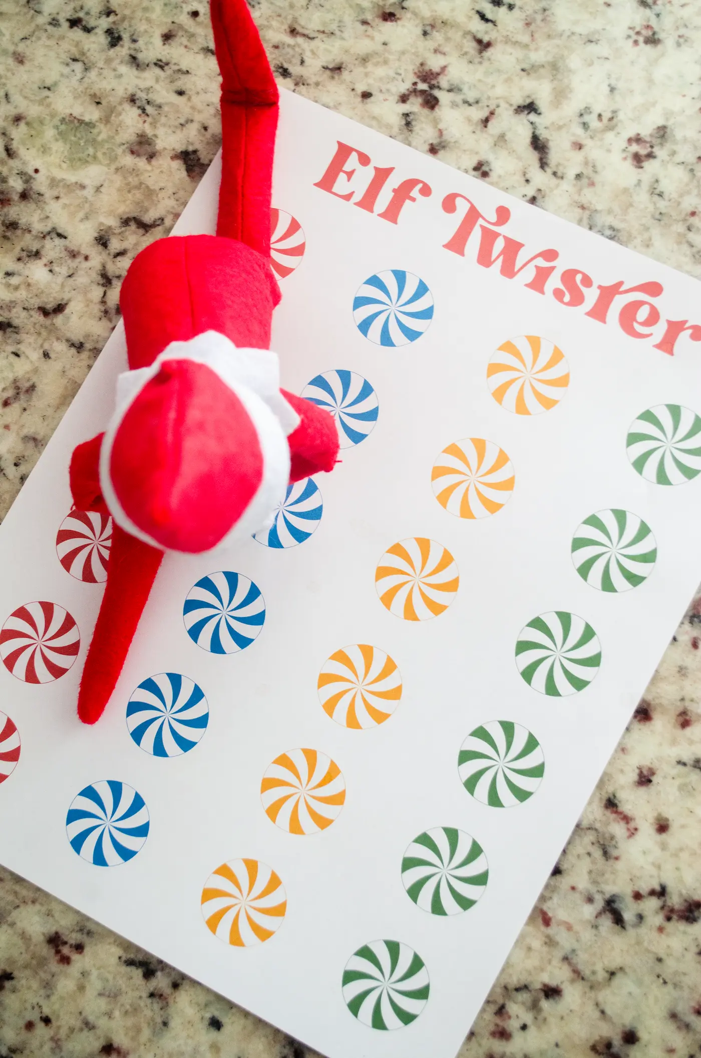 Elf on the shelf playing twister.