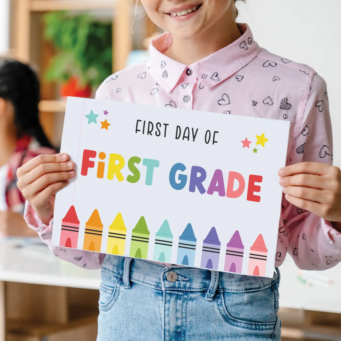 Young girl holding a first day of school sign.